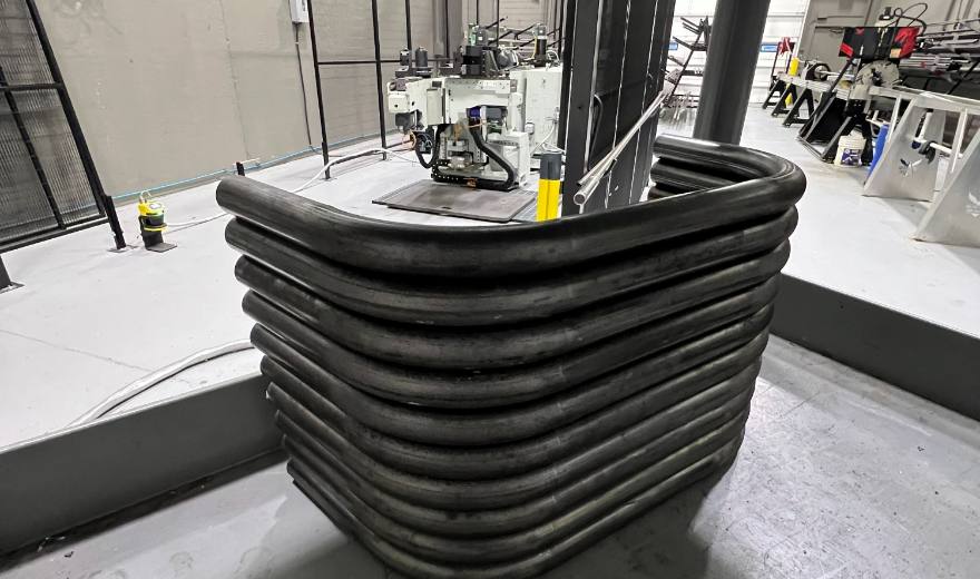 A stack of CNC bent tube, every bend identical, waiting to be welded up