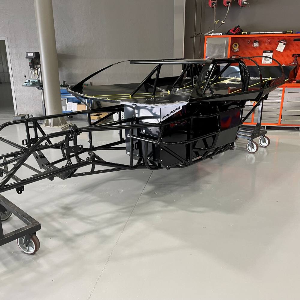 A powder coated race chassis up on stands, part way through assembly