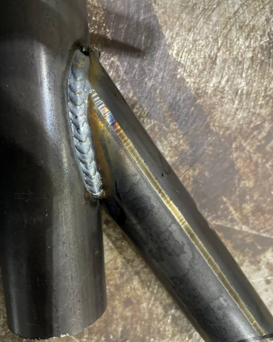 Close up of a TIG weld running around a notched chassis tube joint