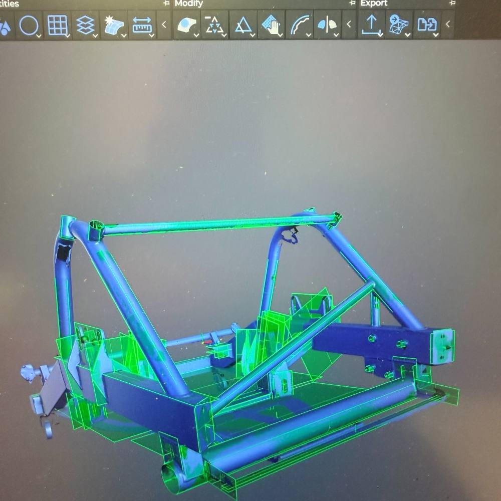 Scan data of a chassis sub frame with modelled geometry laid over it in green