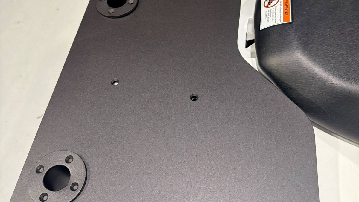 A CNC cut panel finished in textured black powder coat and fitted to the machine