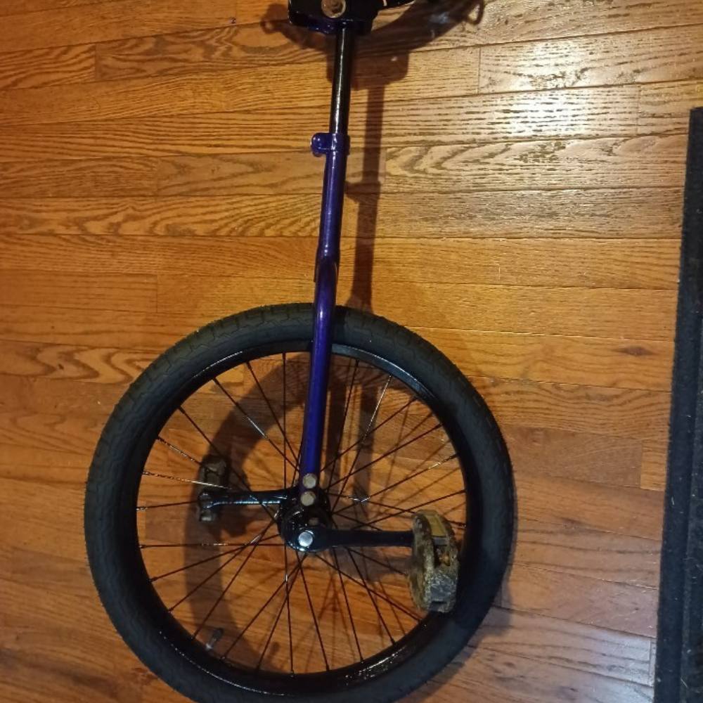 The same unicycle frame after coating, finished in candy purple