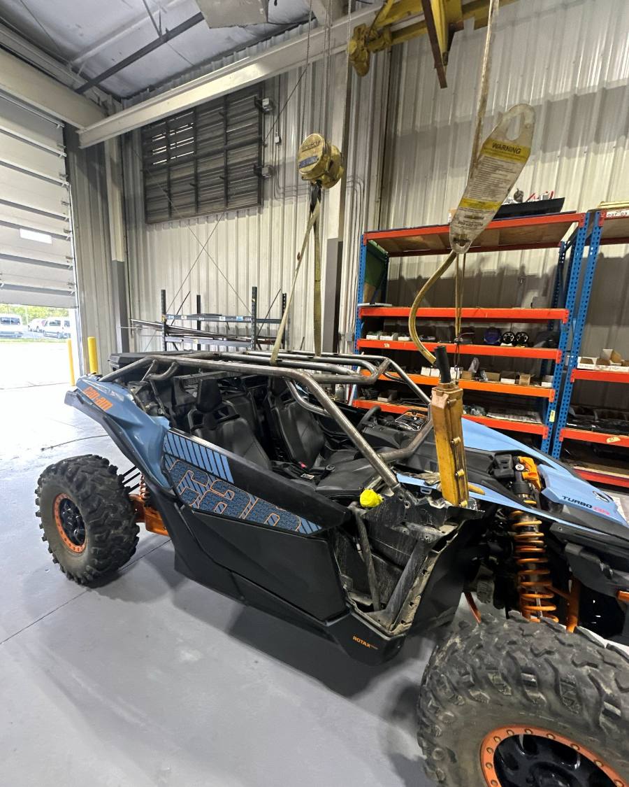 A side by side slung from the hoist with its cage being fitted