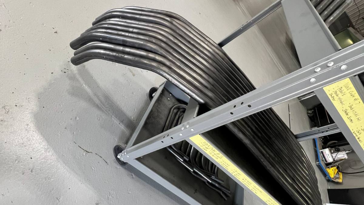 A rack of CNC bent hoops, every bend the same as the last