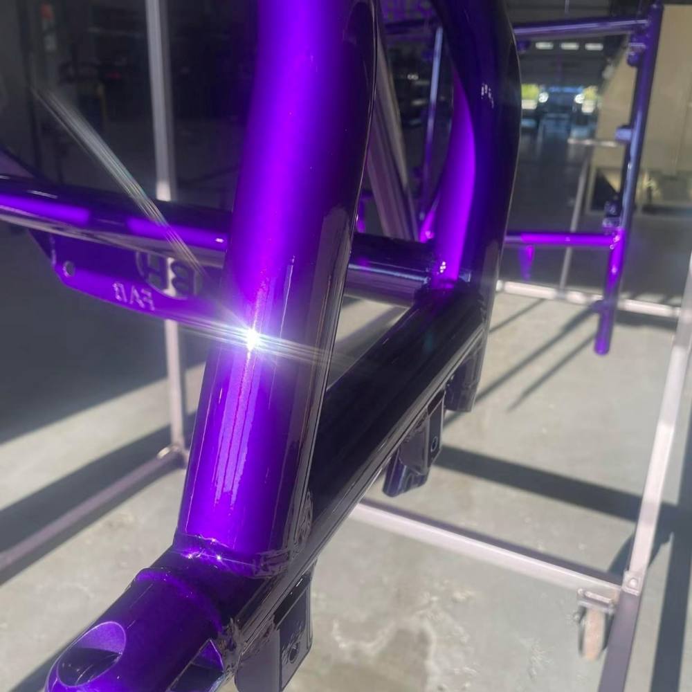 A chassis finished in candy purple powder coat, still on the rack