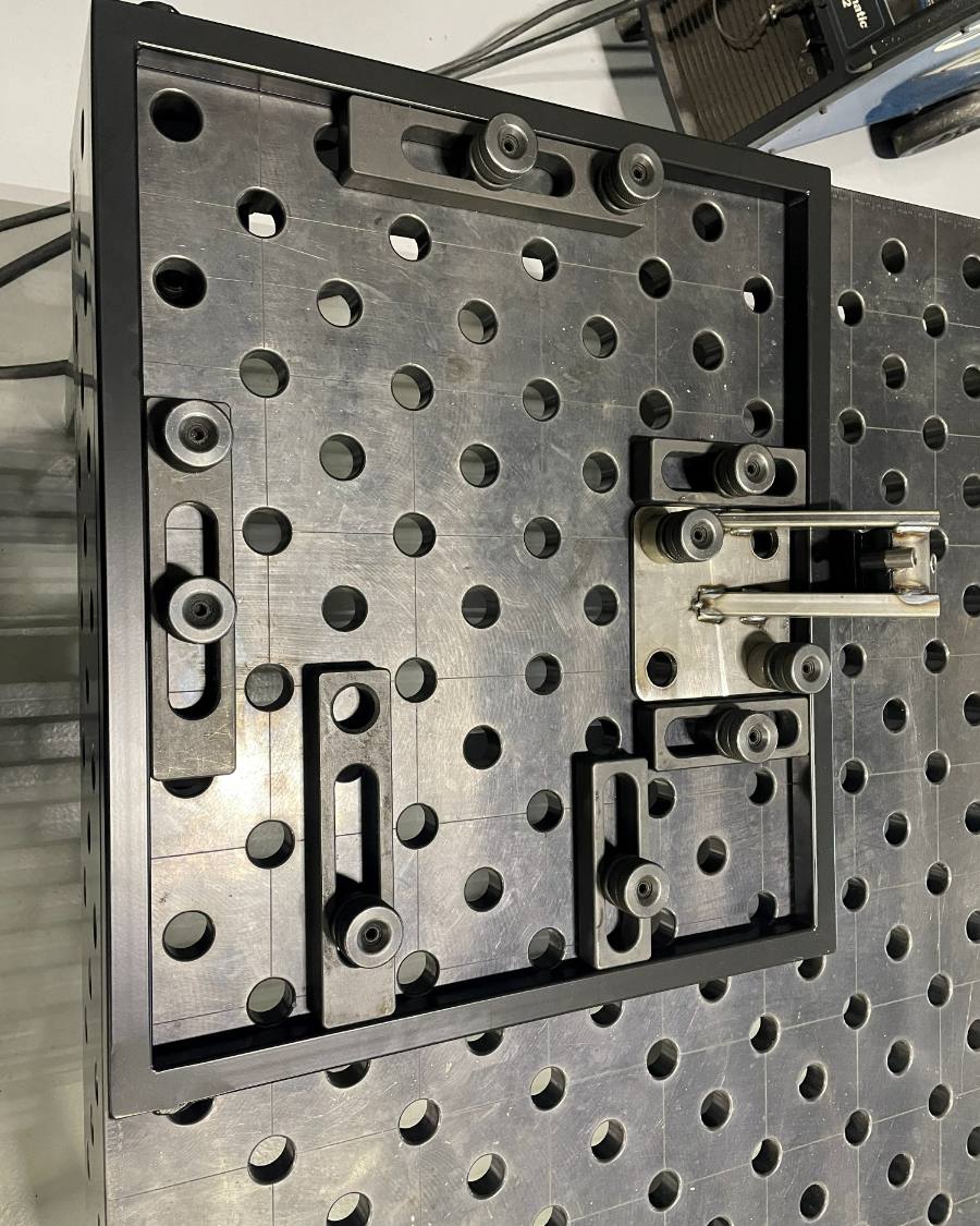 A welded frame located on the fixture table with stops and clamps