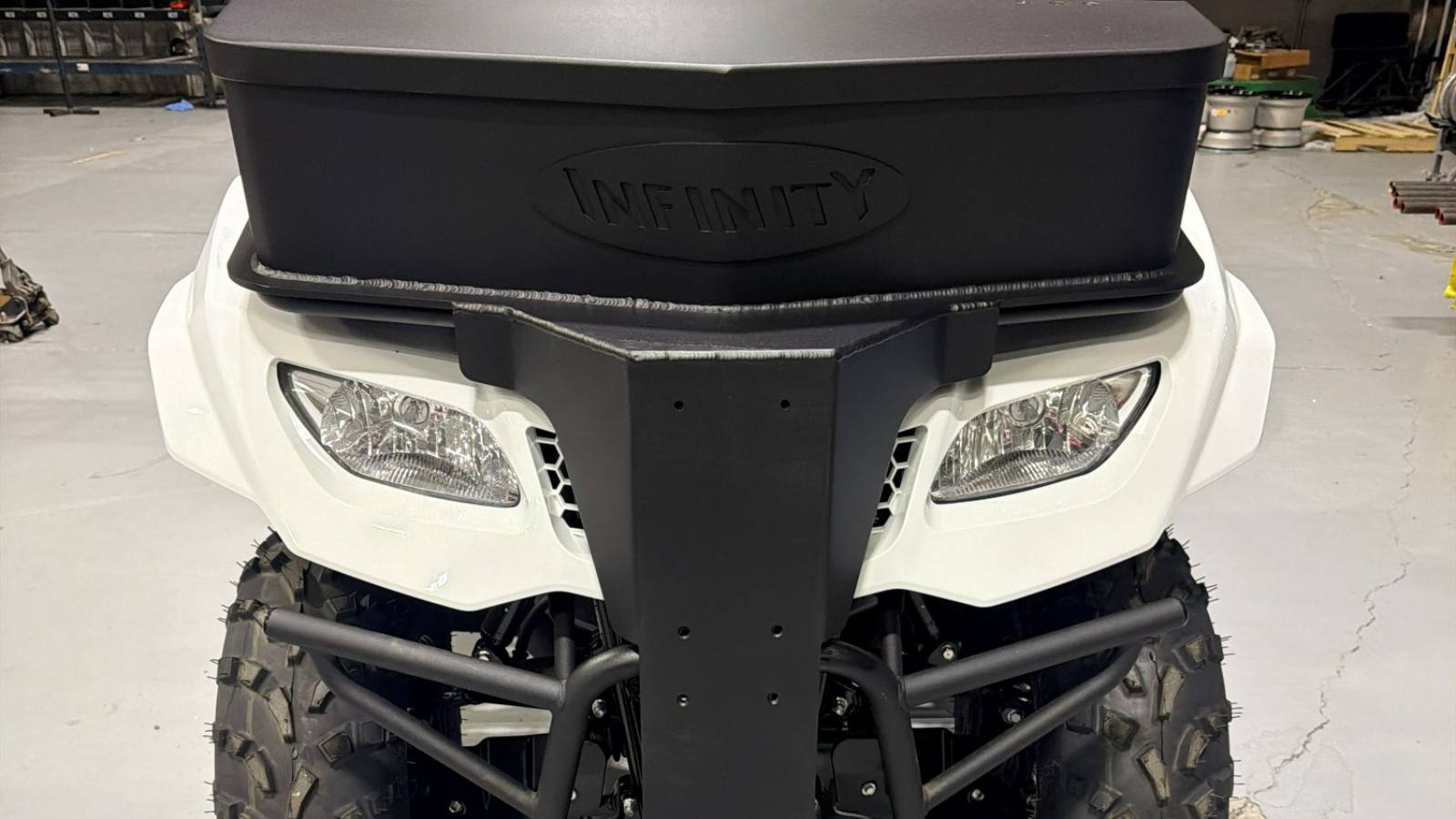 A utility quad fitted with a fabricated cargo box and front bumper, built in the shop