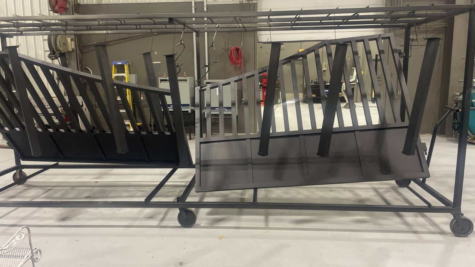 Steel railings and handrail sections on the rack after coating