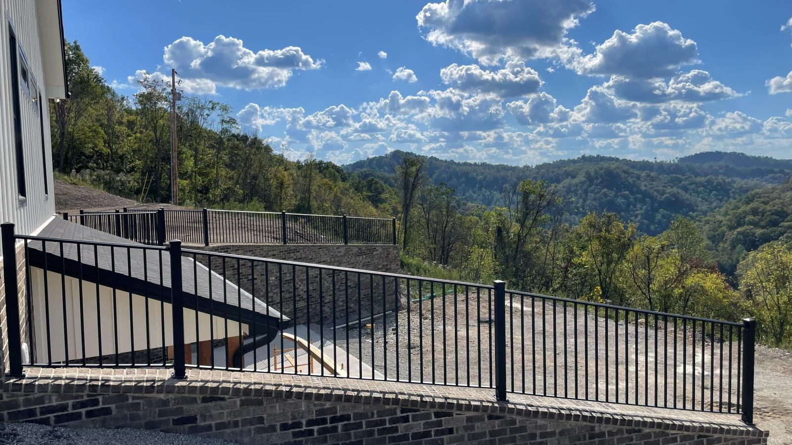 Powder coated steel railing installed on a hillside deck