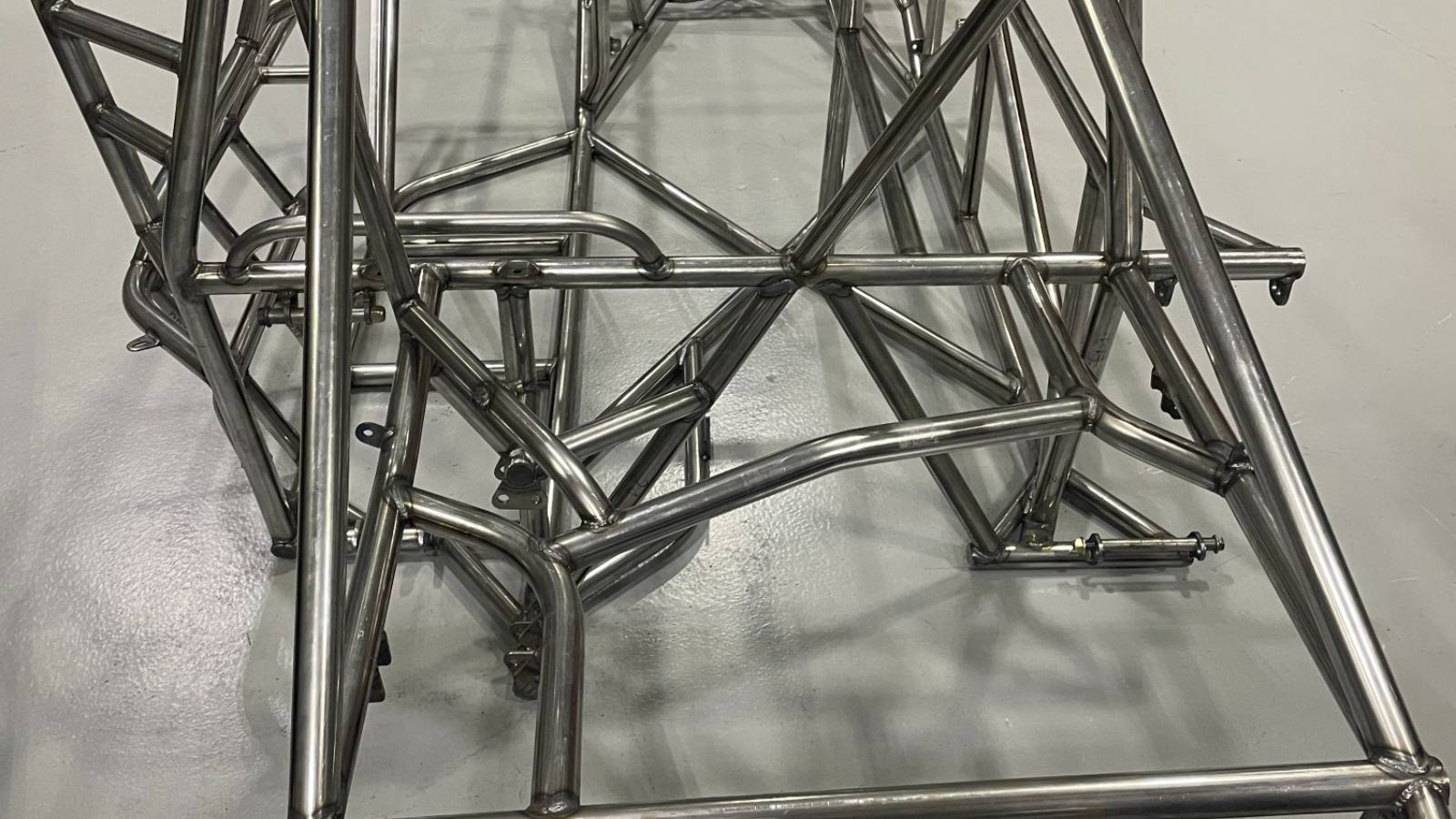 A completed motorsports tube chassis, welded up and standing in the shop