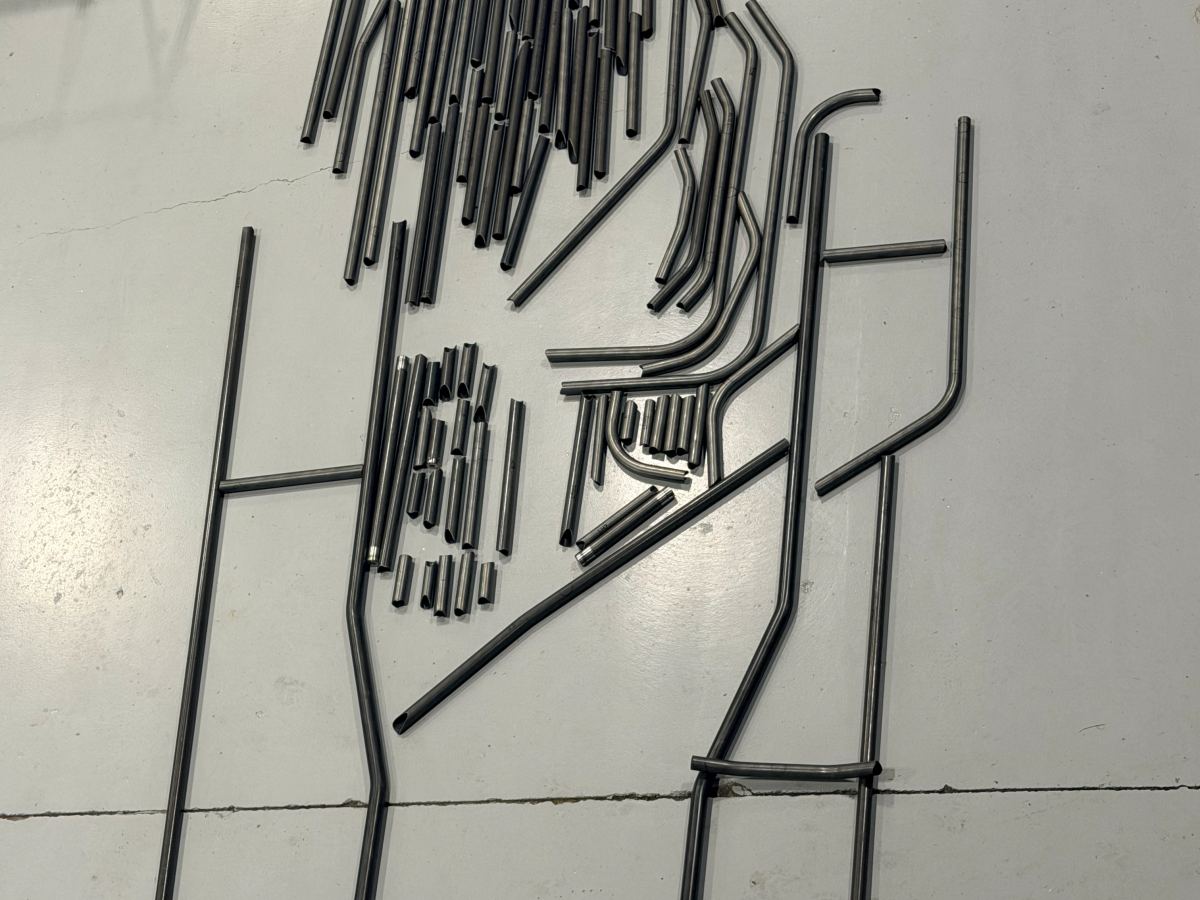 A full chassis kit cut, notched and bent, laid out on the shop floor
