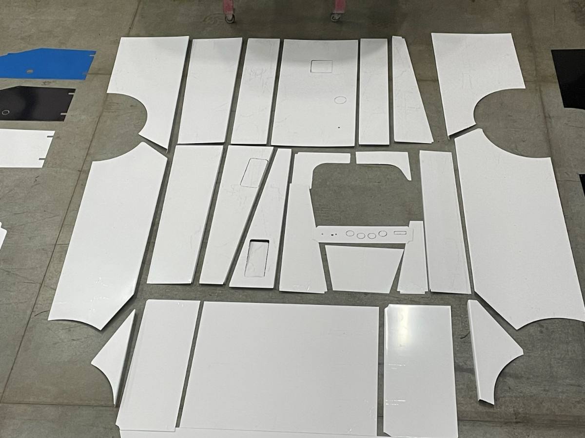 CNC cut and formed sheet metal panels laid out on the shop floor