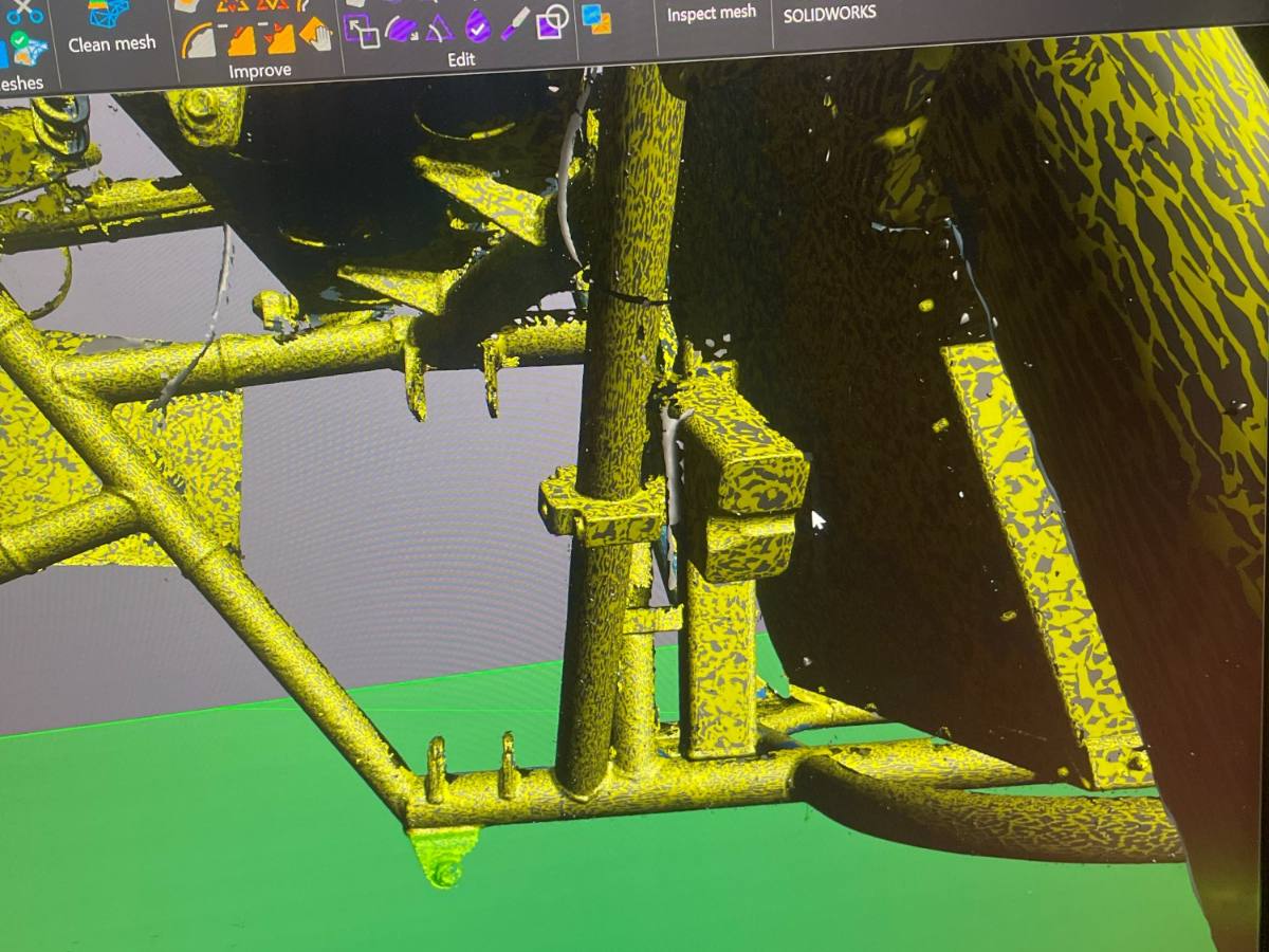 Scan mesh of a chassis being cleaned up in the modeling software