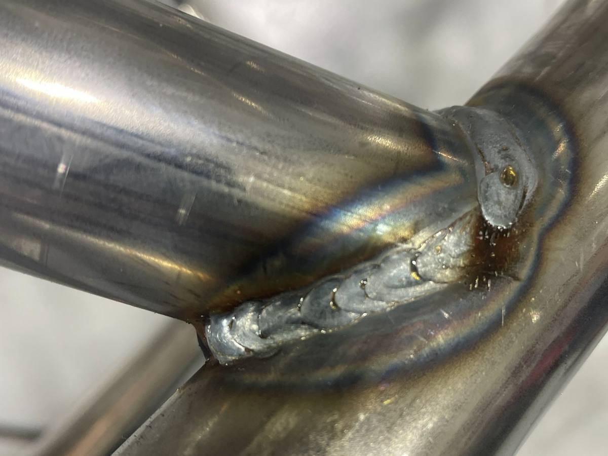 Close-up of a finished weld where two chassis tubes meet